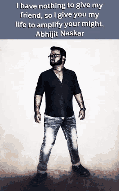 a man in a black shirt and jeans stands in front of a quote by abhijit naskar