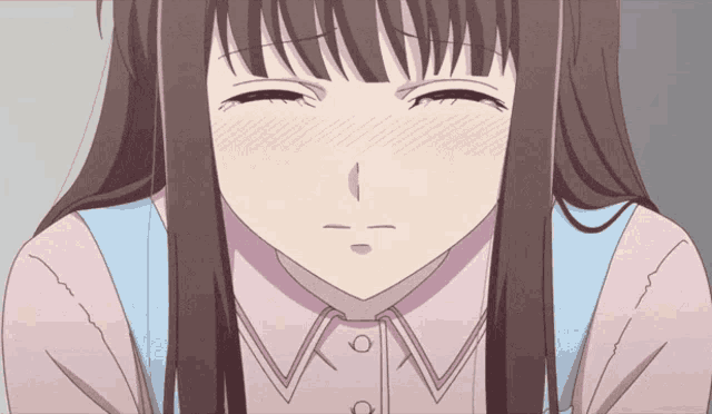 a close up of a girl with her eyes closed and a pink shirt on