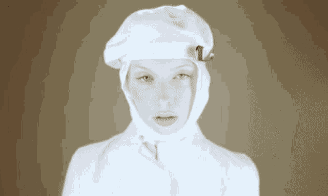 a woman wearing a white hat and a white coat