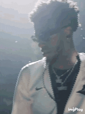 a man wearing sunglasses and a white nike jacket