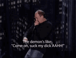 a man is holding a microphone and saying " the demon 's like "