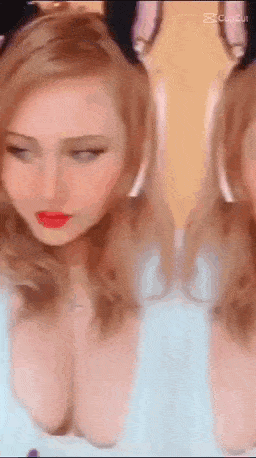 a close up of a woman 's face with her eyes closed and her breasts showing .