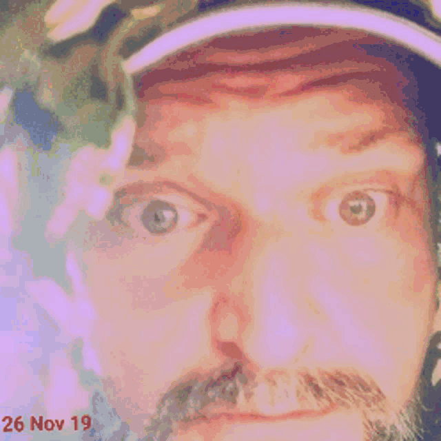 a close up of a man 's face with the date 26 nov 19 on it