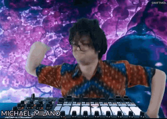 a man is standing in front of a mixer with the name michael milano on the screen