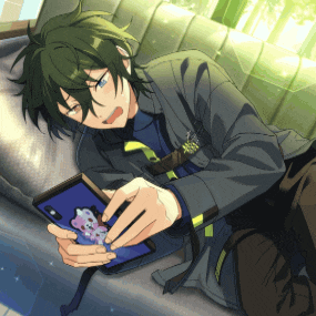 a man with green hair is laying on a couch looking at his phone