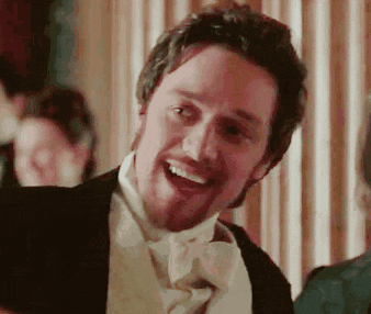 a man in a tuxedo and bow tie is smiling with his mouth open