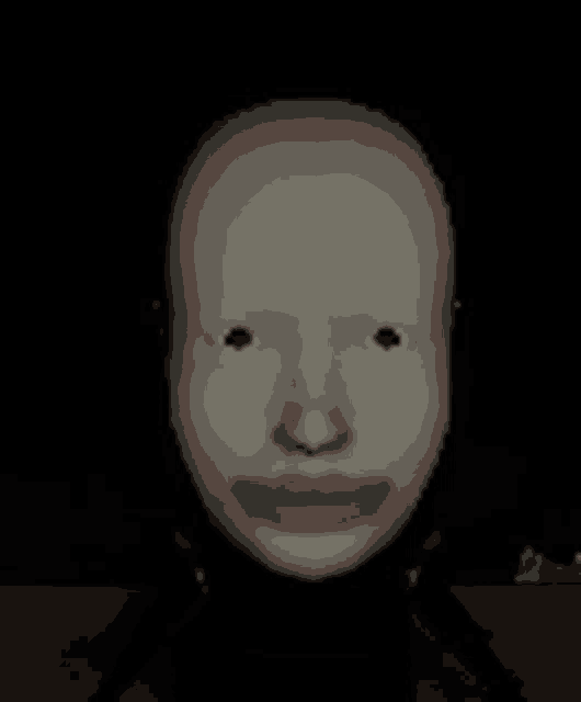 a white head with red lips is sitting on a tripod in the dark .