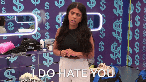 a woman says i do hate you in front of a wall with dollar signs on it