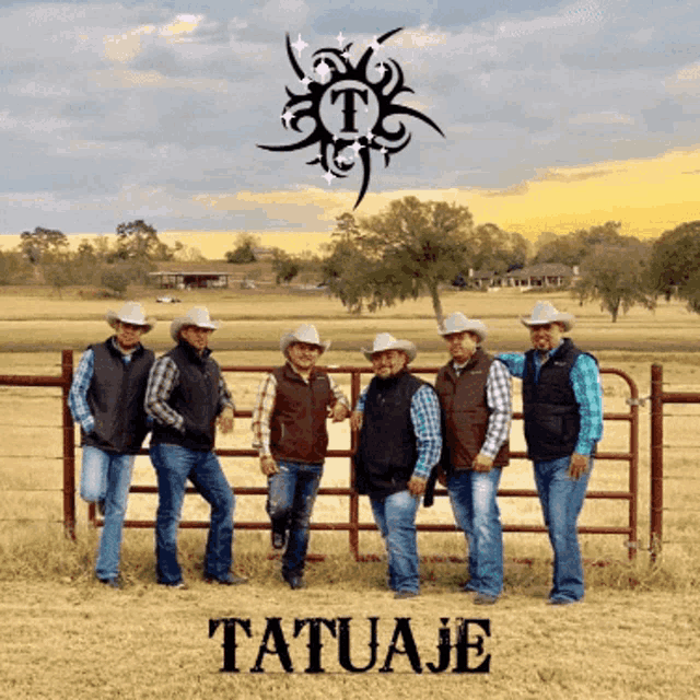 a group of men in cowboy hats are standing next to a fence with the word tatuaje on the bottom