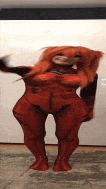 a woman in a red costume with a mask on her face