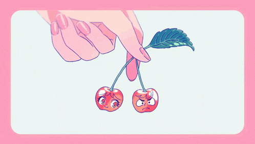 a woman 's hand is holding a pair of cherries with faces on them