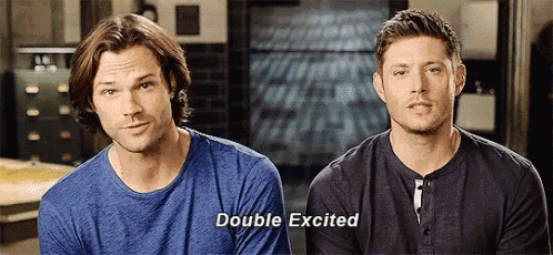 two men are sitting next to each other and one of them is talking .