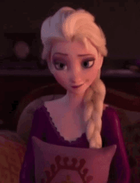 elsa from frozen is sitting on a couch with a pillow in her lap .