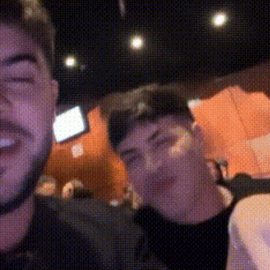 a man with a beard is taking a selfie with another man .