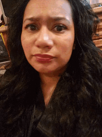 a close up of a woman 's face with her eyes closed