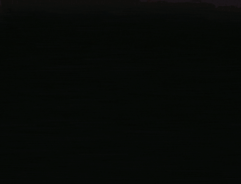 a red and white circle with a hole in the middle on a black background
