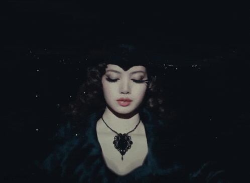 a blurred image of a person in a dark room with a few lights behind them