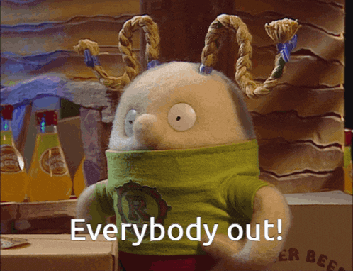 a stuffed animal with a green shirt that says " everybody out " on it