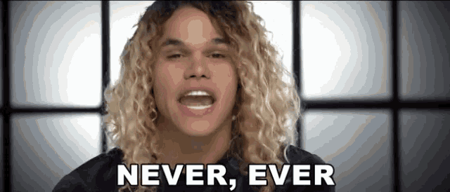 a man with curly hair says " never ever "