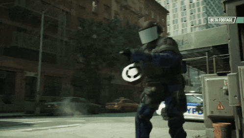 a police officer is walking down a street with a beta footage sign above him