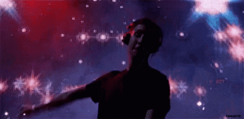 a silhouette of a man dancing in front of a screen that says ' cosmo '
