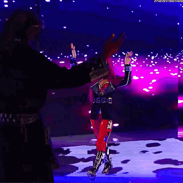 a man and a woman on a stage with the next thing written on the bottom right corner