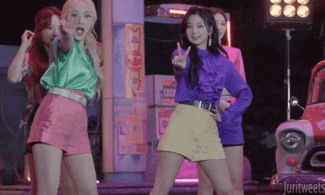 a group of girls are dancing in front of a sign that says lucky 's