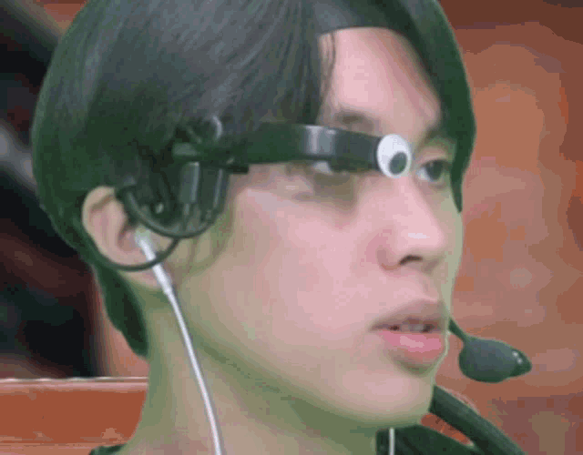 a close up of a person wearing a headset and ear buds