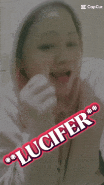 a woman wearing a white hoodie with the word lucifer on the front