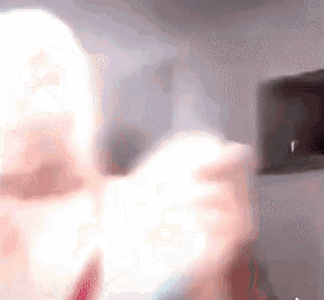a blurry picture of a woman holding a light bulb in her hand .