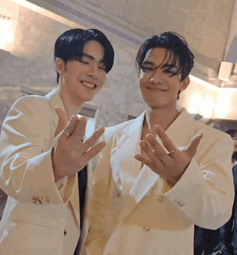 two men wearing white suits are standing next to each other