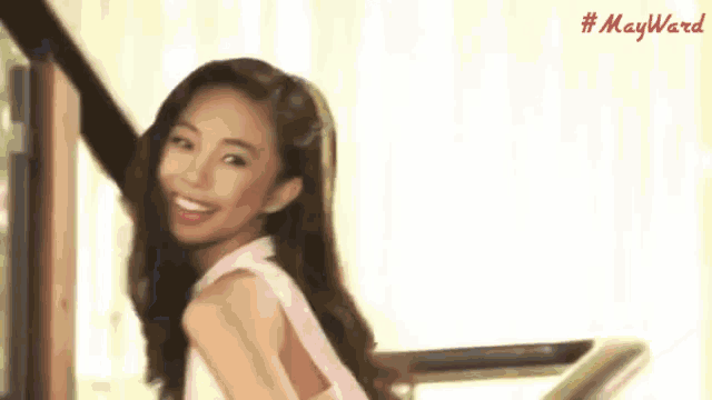 a woman in a pink dress is smiling in front of a white background with the hashtag #mayward