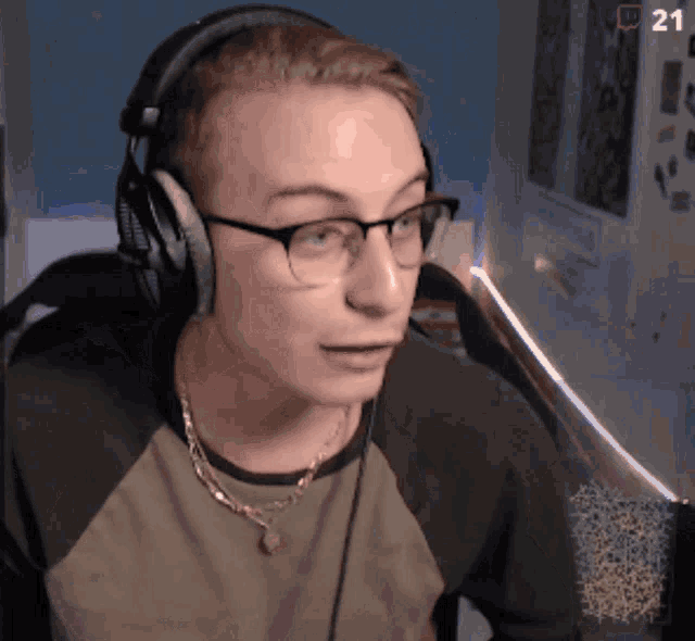 a man wearing headphones and glasses has the number 21 next to his face