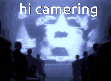 a group of people standing in front of a screen that says hi camering