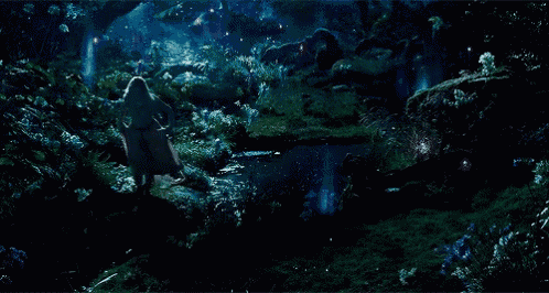 a woman is walking through a dark forest with a sword in her hand