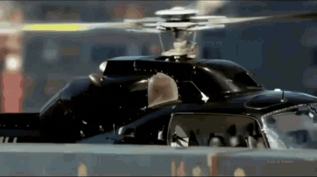 a close up of a helicopter 's propeller with the letters aa on the bottom right corner