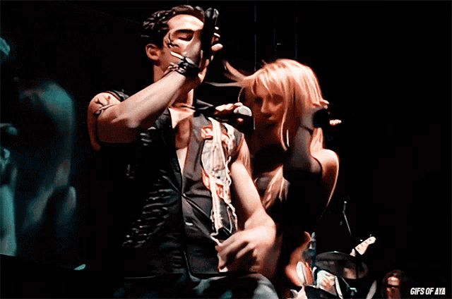 a man and a woman are dancing on a stage and the words gifs of aa are on the bottom right
