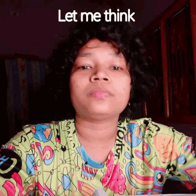 a woman wearing a colorful shirt with the words let me think above her