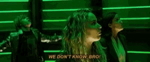 a woman is standing in front of a green light and says `` we don 't know bro '' .