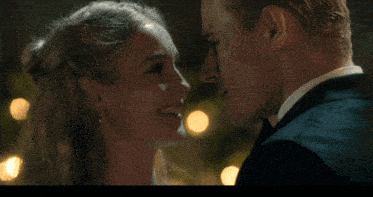a bride and groom are kissing in front of a wall with the words so what do we do now