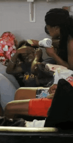 a group of people sitting on a couch with one wearing a shirt that says lakers