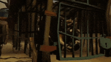 a man is standing in a cage with a sword in his hand .