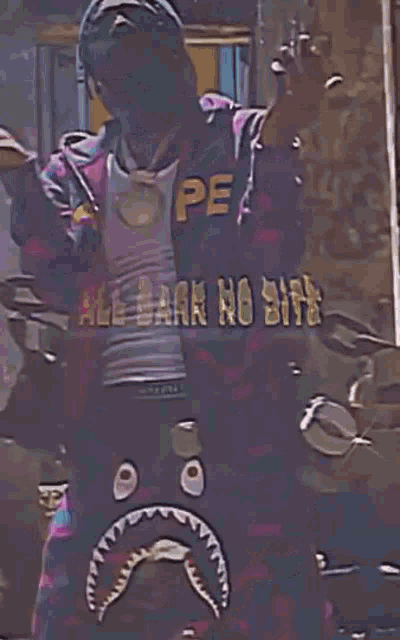 a man wearing a shark shorts and a hoodie with a sad face on it .