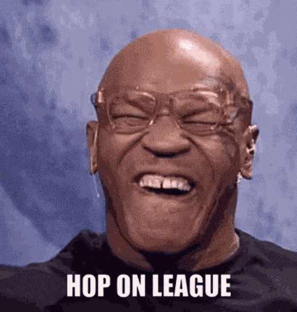 a bald man wearing glasses is laughing with the words hop on league written on his face .