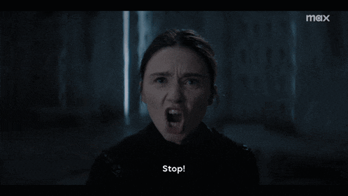 a close up of a woman screaming with the word stop in the corner