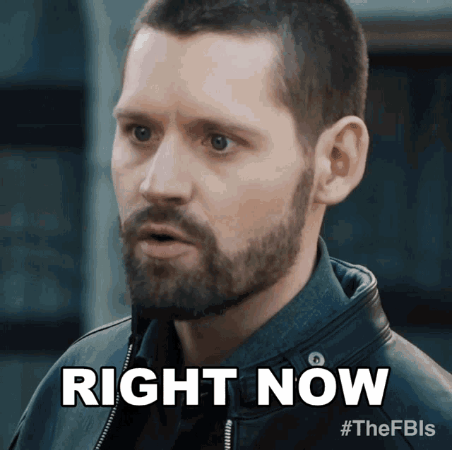 a man with a beard is wearing a leather jacket and says " right now "