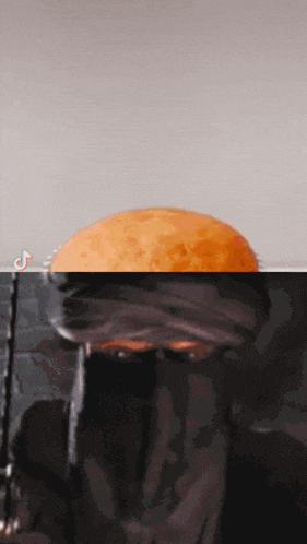 a tiktok video shows a person holding a donut in a glass