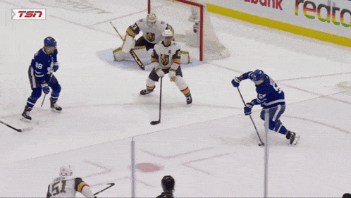a hockey game is being played in front of a scotiabank sign