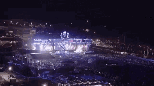 an aerial view of a large crowd of people at a concert at night