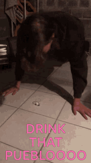 a man is doing push ups on a tiled floor with the words drink that puebloooo on the bottom